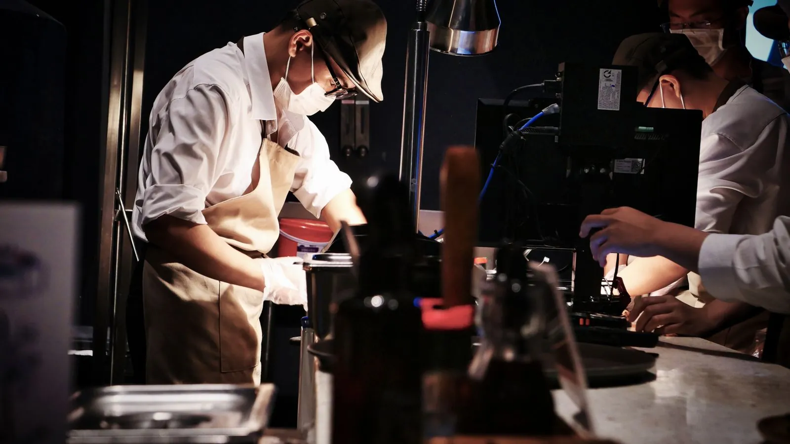 Cuisine professionnelle de dark kitchen avec sacs de commande à livrer alignés sur le passe